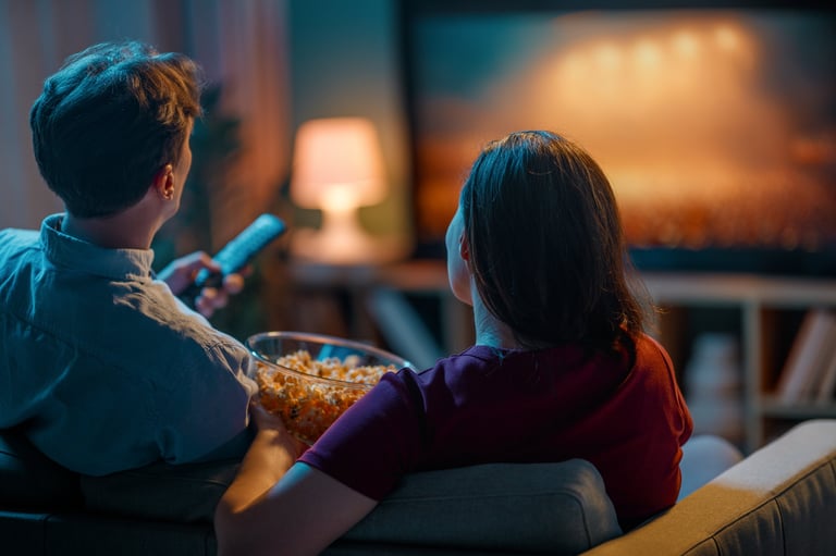 Couple relaxing on sofa watching movie